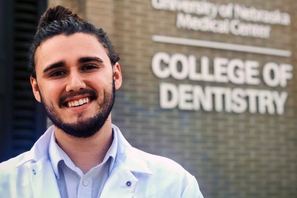 Student standing in front of UNMC College of Dentistry
