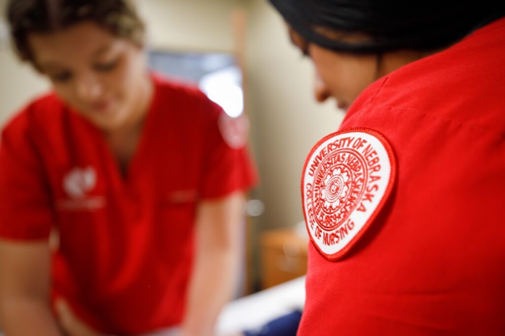 UNMC College of Nursing student with patch on her scrubs