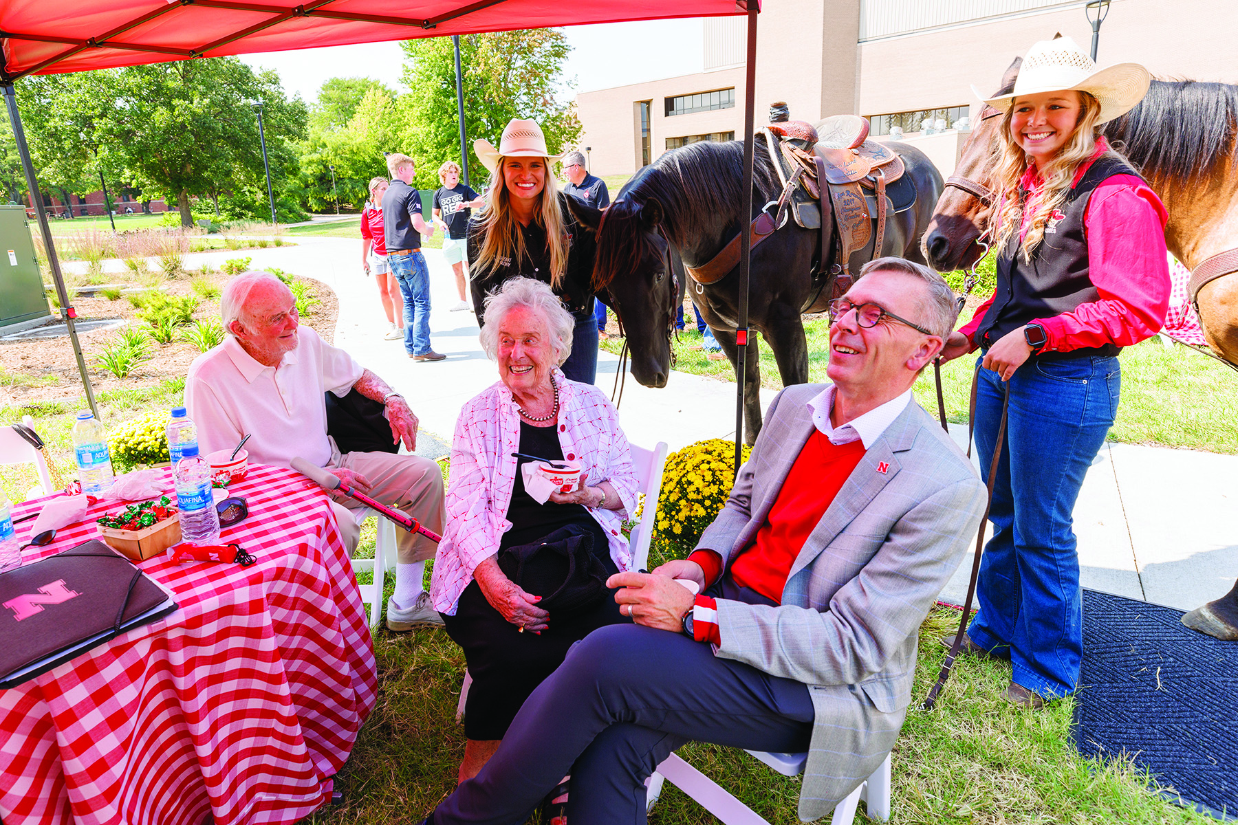 From left, Bill and Ruth Scott and Chancellor Ronnie Green pose with UNL Rodeo Club members Hallie Reeves, left, and Sydney Veldhuizen and their horses. The Scotts were honored at the dedication of the George Beadle statue at the Dinsdale Learning Commons on East Campus. September 13, 2022. Photo by Craig Chandler / University Communication.